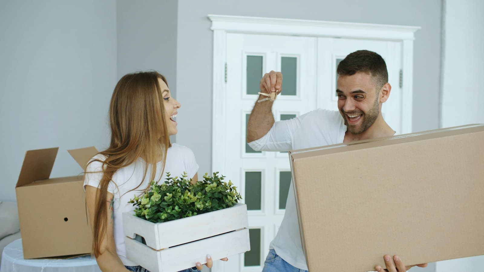A couple holding up the keys to their new home