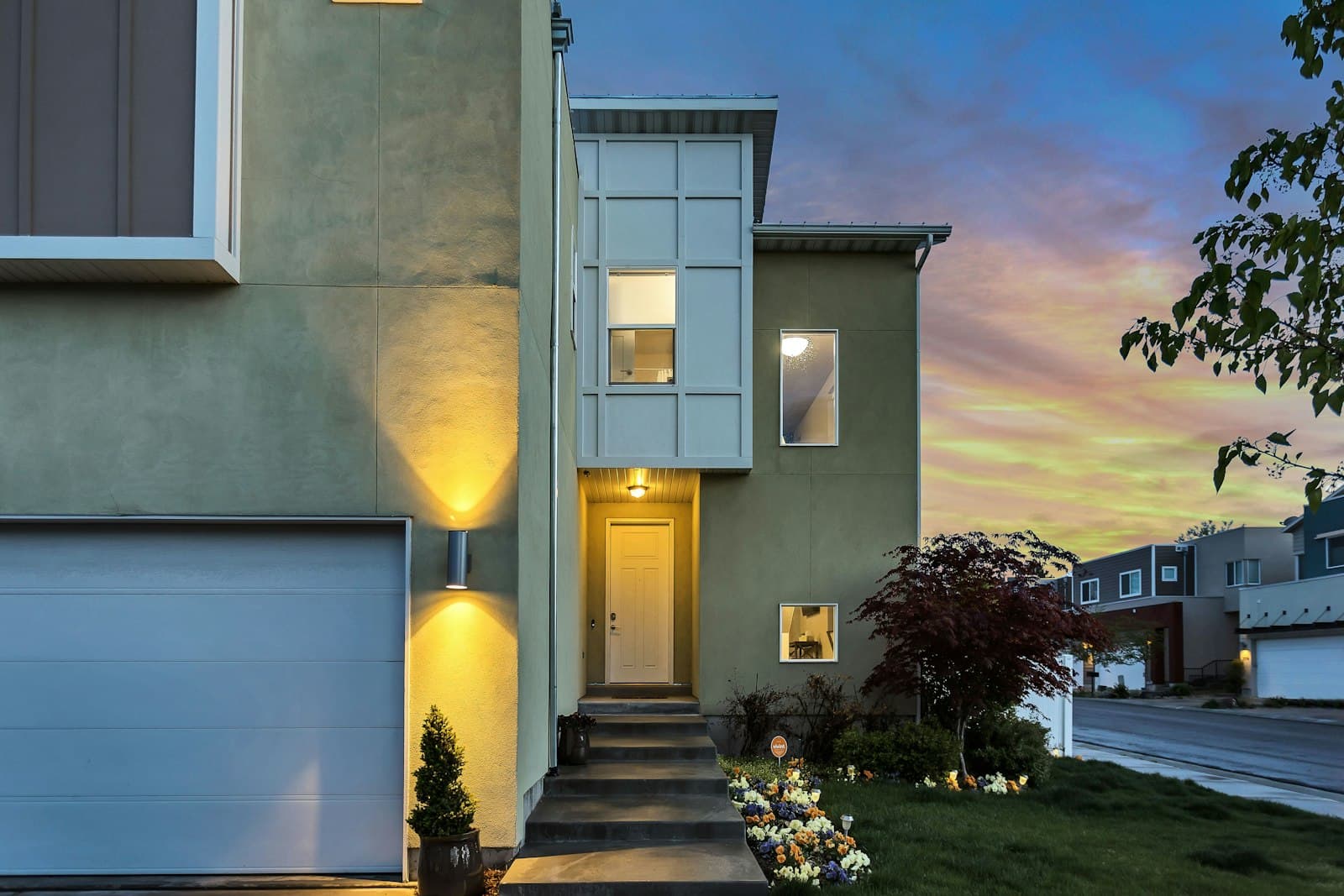 A home with its lights on at dusk