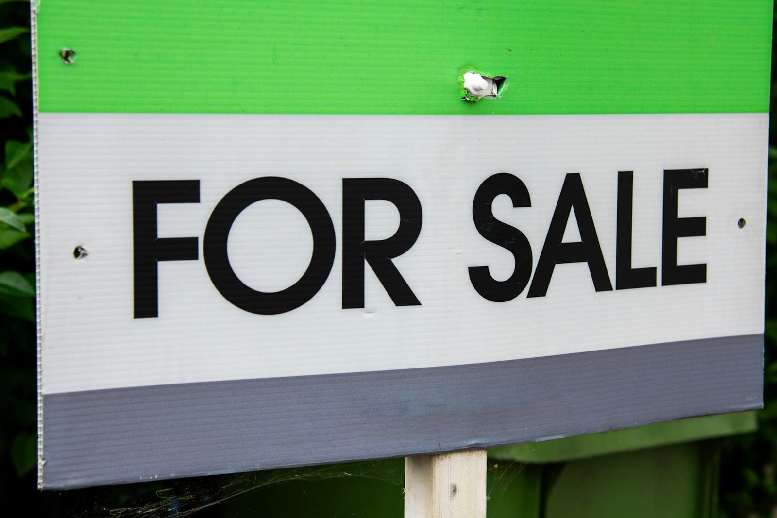 A for sale sign in front of a home